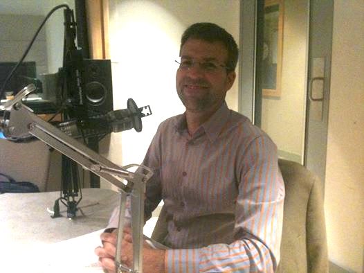 Jeremy Adam Smith prepares for an interview at KALW's studios in 2014.