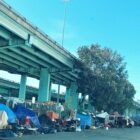 Tents housing homeless residents of San Francisco line a street below the freeway in 2017.