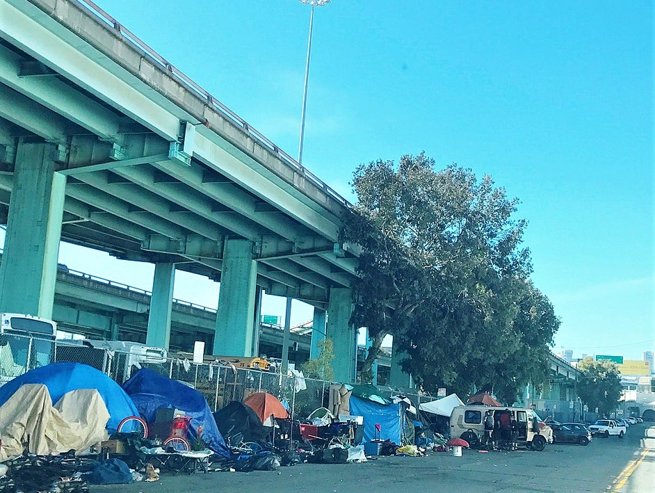 Tents housing homeless residents of San Francisco line a street below the freeway in 2017.