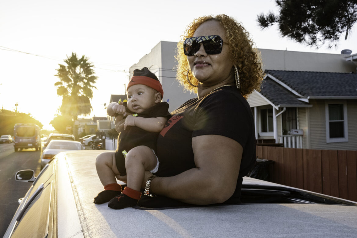 Tantay Tolbert holds her son Supreme Lloyd-Vaughn and poses for a portrait through a limousine sunroof in Richmond. Tolbert has a side business with her partner selling used vehicles, which she acquires from auto auctions. The couple fixes mechanical issues and sells the vehicles for a profit. In August, they acquired their first limousine with the intention of expanding their business into car rentals. But the coronavirus pandemic has slowed that side of the business, so the couple takes it out on Sundays for family party drives.