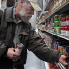 File photo: San Francisco Food Bank volunteer Jim Caddick stocks shelves with soup in 2012.