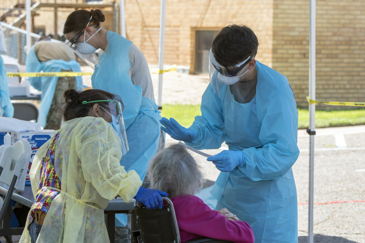 U.S. Army Spc. Sterling Hutcheson, a medic with the Colorado National Guard Joint Task Force Test Support, prepares to swab a nursing home resident during COVID-19 testing in Rocky Ford, Colo. on May 29, 2020.