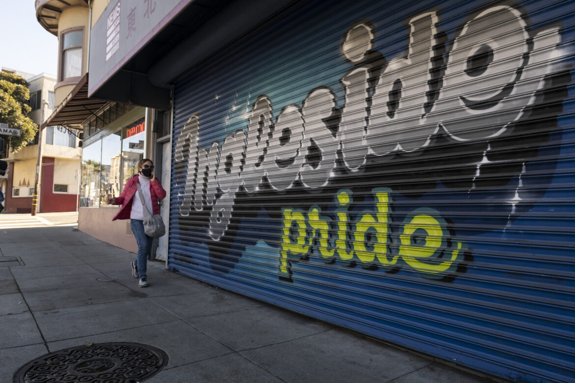 A woman chats on her phone, wearing a mask,while walking down Ocean Avenue in early January.She strolls pass a mural highlighting, “Ingleside Pride,” painted on a closed medical business. Residents in the neighborhoods of Ingleside, Excelsior, Mission and the Tenderloin are struggling to continue paying rent.Despite the region’s high rents, the percentage of San Francisco area residents who are behind on their rent is lower than the national average.