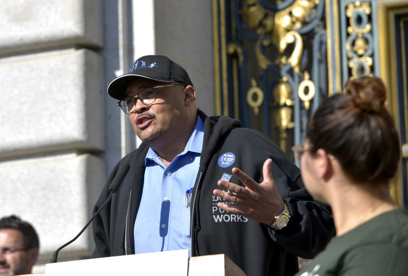 Former San Francisco Public Works Director Mohammed Nuru speaks at a rally asking for walking safety during seventh annual Walk to Work Day at City Hall on April 10, 2019. Speaker of the House Nancy Pelosi, left, and San Francisco Mayor London Breed, center, join then-Transbay Joint Powers Authority Board Chair Mohammed Nuru in turning on a bus schedule screen to celebrate the opening of the new Salesforce Transit Center. Nuru was arrested by the FBI in 2020 on corruption charges.