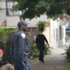 A man sits on the sidewalk with has hands restrained behind him while police officers look on.Four police officers responded to a call in March 2020 about a homeless man in the Castro.