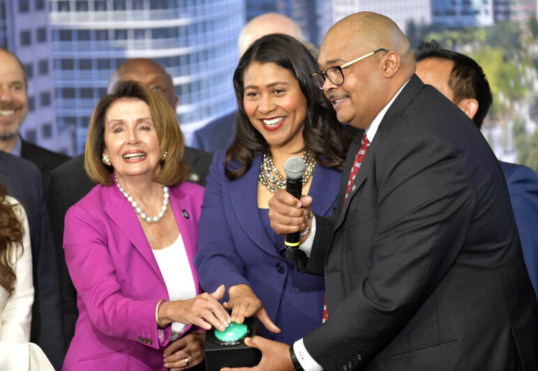 Speaker of the House Nancy Pelosi, left, and San Francisco Mayor London Breed, center, join then-Transbay Joint Powers Authority Board Chair Mohammed Nuru in turning on a bus schedule screen to celebrate the opening of the new Salesforce Transit Center.