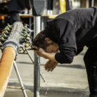 Tony Campana washes his face at a water pipe installed by San Francisco in the Tenderloin.