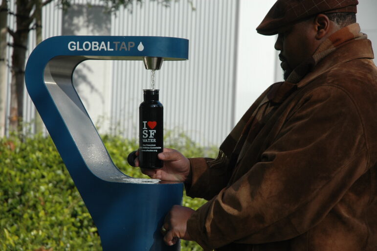 A man fills his water bottle at one of San Francisco's new permanent water fountains.