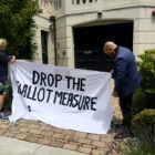 At a July 2020 car caravan and protest, ride hail drivers displayed a banner against Proposition 22 in front of Uber CEO Dara Khosrowshahi’s home in San Francisco.