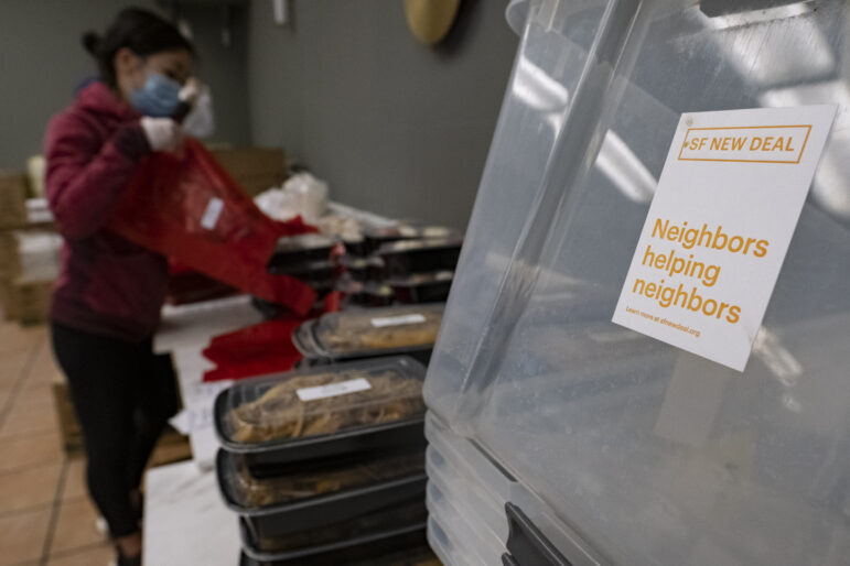 Chelsea Hung, owner of Washington Bakery, bags breakfast, lunch and dinner meals for distribution through the SF New Deal program.