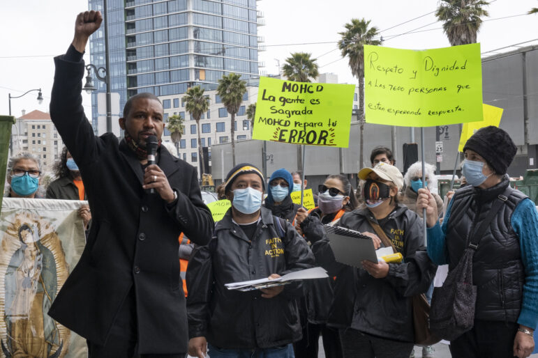 Supervisor Shamann Walton, left, speaks alongside a small group of Faith in Action advocates who are protesting outside the city's housing office, demanding that the City's new rental assistance program include almost 7,600 applications for monetary aid submitted as part of its Give2SF program last year. Walton said he "supports families needing family relief" and asks for the city to "take into consideration people already on the list. They already have expressed the need, and now we need to help them."