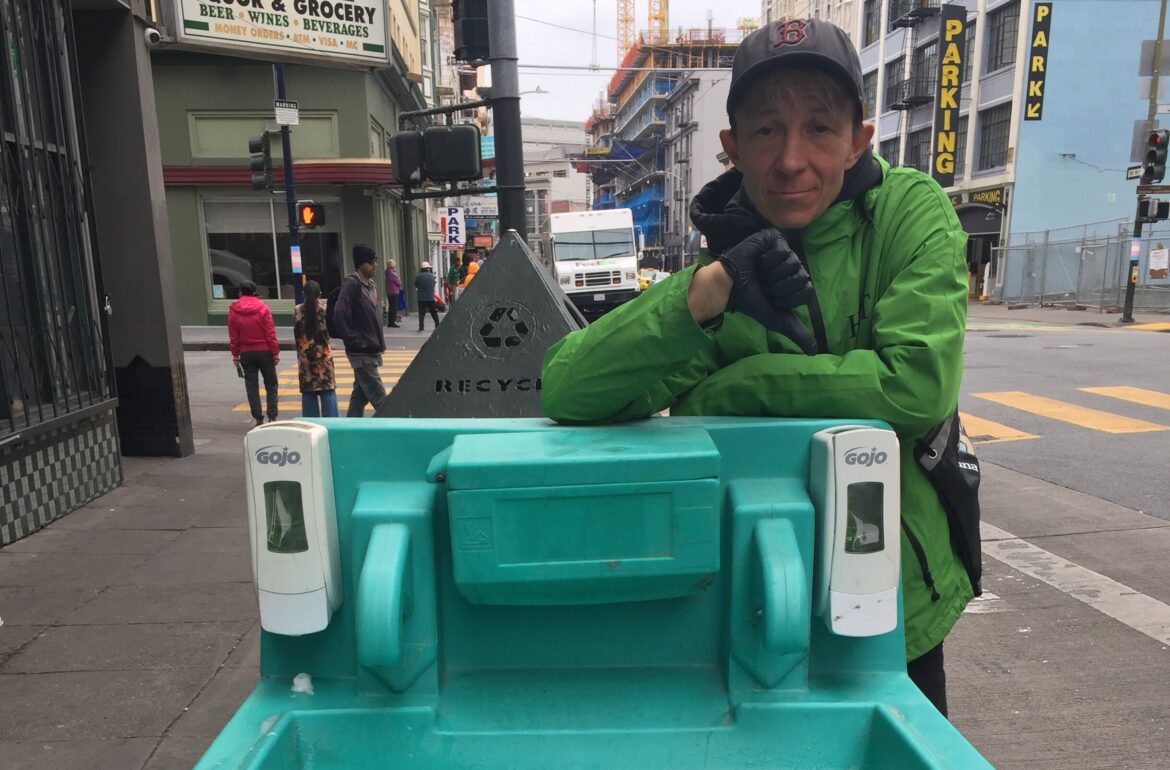 A Homeless Outreach Team worker inspects a handwashing station and finds that it needs to be refilled in the summer of 2020, at a time when coronavirus health and safety guidelines emphasized hygiene, not masks, as the best method to contain the spread of COVID-19.