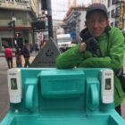 A Homeless Outreach Team worker inspects a handwashing station and finds that it needs to be refilled in the summer of 2020, at a time when coronavirus health and safety guidelines emphasized hygiene, not masks, as the best method to contain the spread of COVID-19.