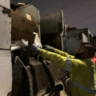 Recycling driver Gareth Willey ensures that cardboard is properly loaded into his truck.