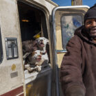 Edward Armstrong smiles after petting his Pitbull dogs, which live in his recreational vehicle on Carroll Avenue in the Bayview neighborhood.