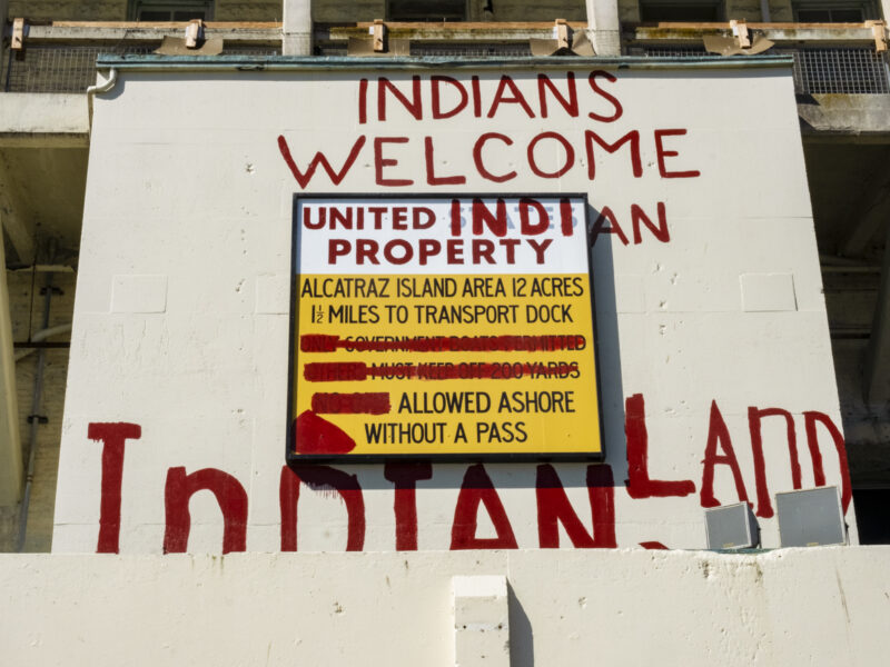 The occupiers used red paint to repurpose a penitentiary sign with a new message: “Indians Welcome. United Indian Property. Alcatraz Island. Area 12 acres. 1 ½ miles to transport dock. Allowed ashore without a pass. Indian Land.”