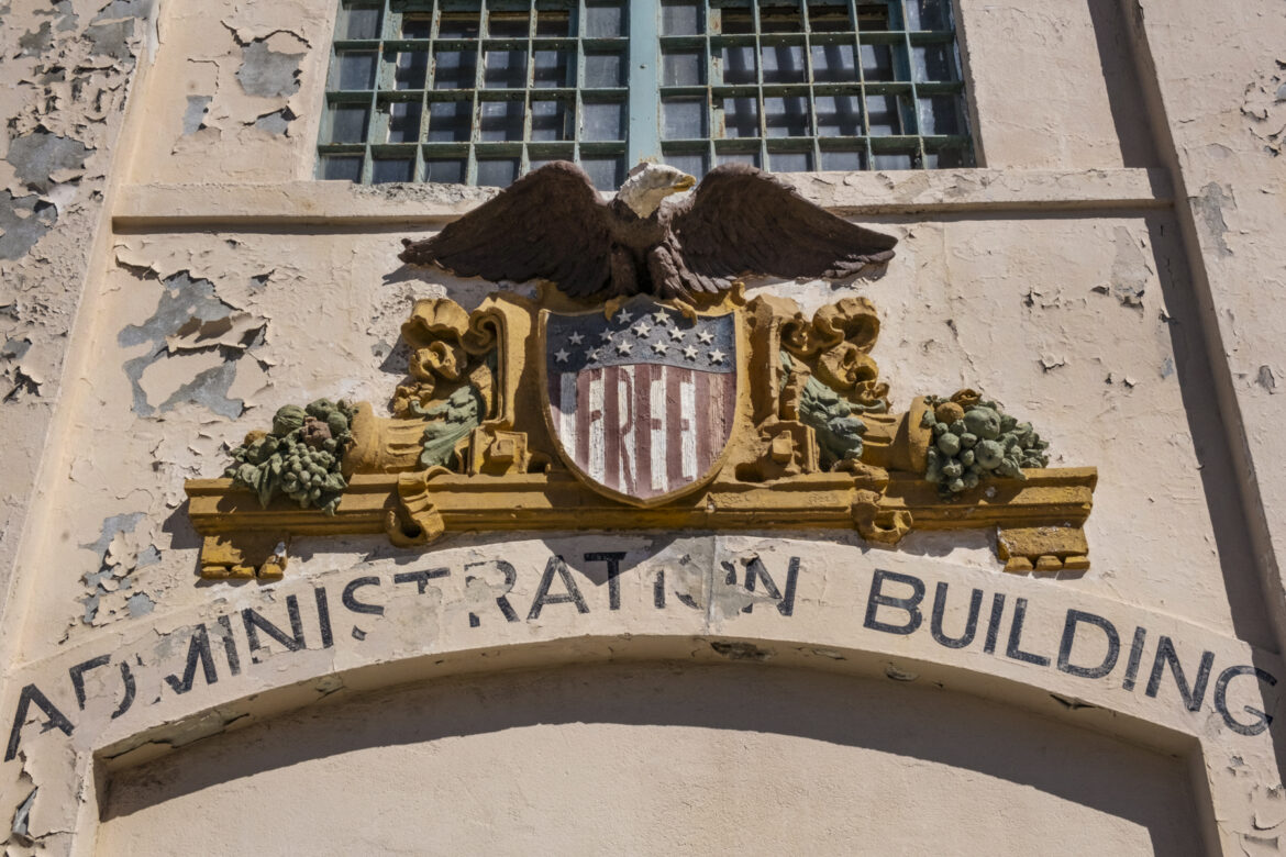 Eagle Plaza, the entrance of the cell house building, features a Bald Eagle above a shield, which occupiers repainted with the word “Free.”