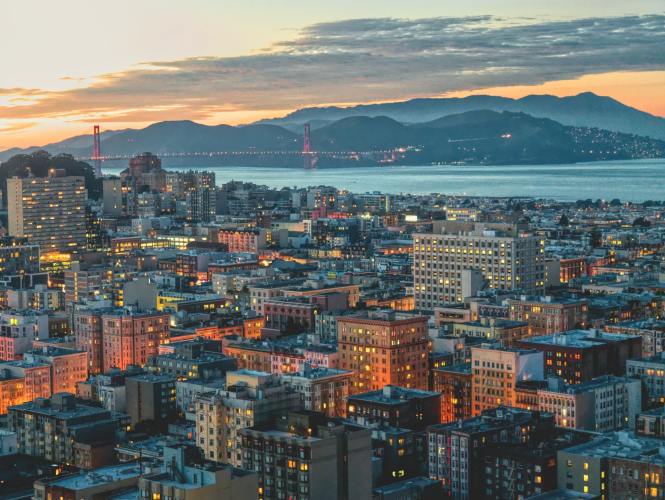A view of San Francisco, the Golden Gate Bridge, and Marin County at sunset.