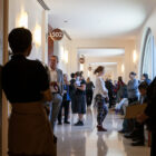 More than a dozen people stand in a hallway leading to courtrooms in San Francisco.