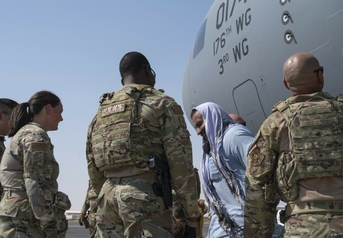 Evacuees from Afghanistan arrive at Ali Al Salem Air Base, Kuwait, on an aircraft crewed by Air National Guard members on Aug. 23, 2021.