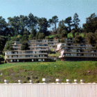 Multiple three-story apartment buildings line a San Francisco hillside in the Potrero Terrace public housing development.