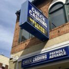 A "check cashing" sign hangs above a storefront. While San Franciscans who owe COVID-19-related rent debt are eligible for relief from the government, those who borrowed from friends, family, and other sources are stuck with that debt.