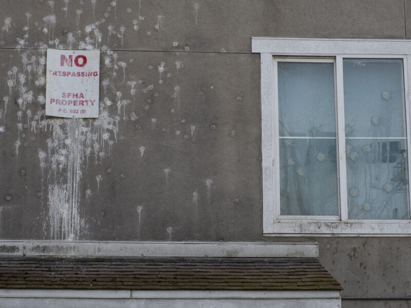 A sign covered in bird droppings that sits above a doorway at San Francisco's Plaza East public housing development reads "No Trespassing. SFHA Property." Tenants at Plaza East describe units that are as damaged and neglected on the inside as they appear externally.