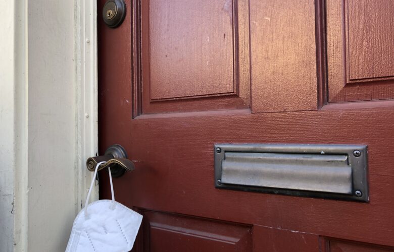 face mask hangs on outside doorknob