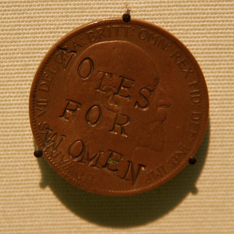 A suffragette defaced penny, with the words "Votes for Women" hammered into it.