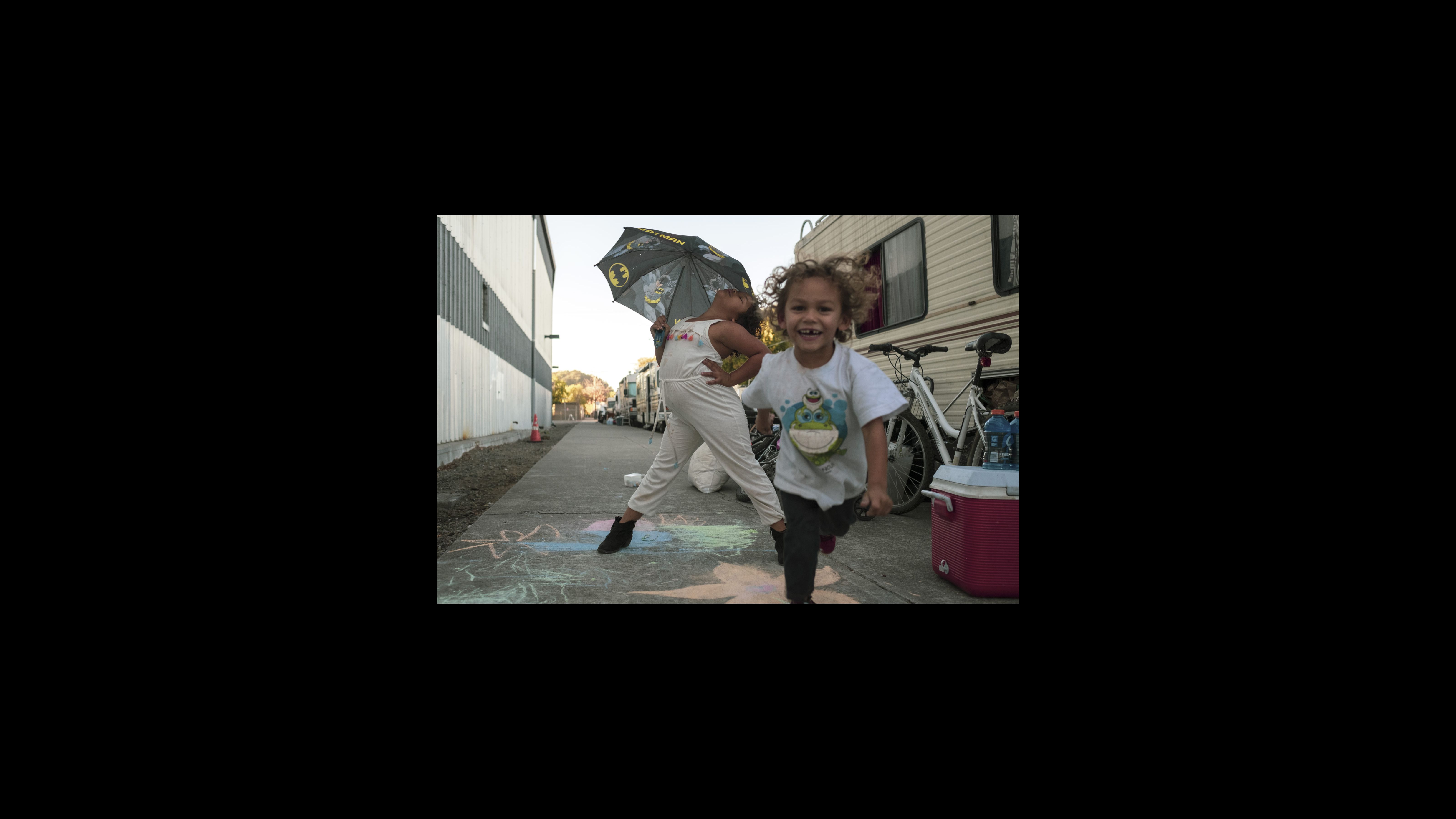 Children play on Eighth Street in West Berkeley while their parents run errands. RV-dwelling neighbors or grandma babysit when the guardians are away. The kids fill the block with laughter and toys as they run up and down the line of vehicles, peeking inside neighbors’ doors to say hello. Children play on Eighth Street in West Berkeley while their parents run errands. RV-dwelling neighbors or grandma babysit when the guardians are away. The kids fill the block with laughter and toys as they run up and down the line of vehicles, peeking inside neighbors’ doors to say hello.