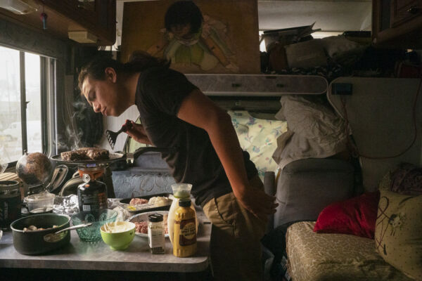 Christian Torres cooks hamburgers on a camping stove. Torres lives inside a Ford E150 white cargo van. He is a photographer from the town of Sanger, near Fresno. He brought his van to the Bay Area, searching for creative opportunities. His daily routine: make breakfast, hit the gym, shower, commute around the city for food and linger at coffee shops or libraries to charge battery packs and electronics for the day. Christian Torres cooks hamburgers on a camping stove. Torres lives inside a Ford E150 white cargo van. He is a photographer from the town of Sanger, near Fresno. He brought his van to the Bay Area, searching for creative opportunities. His daily routine: make breakfast, hit the gym, shower, commute around the city for food and linger at coffee shops or libraries to charge battery packs and electronics for the day.