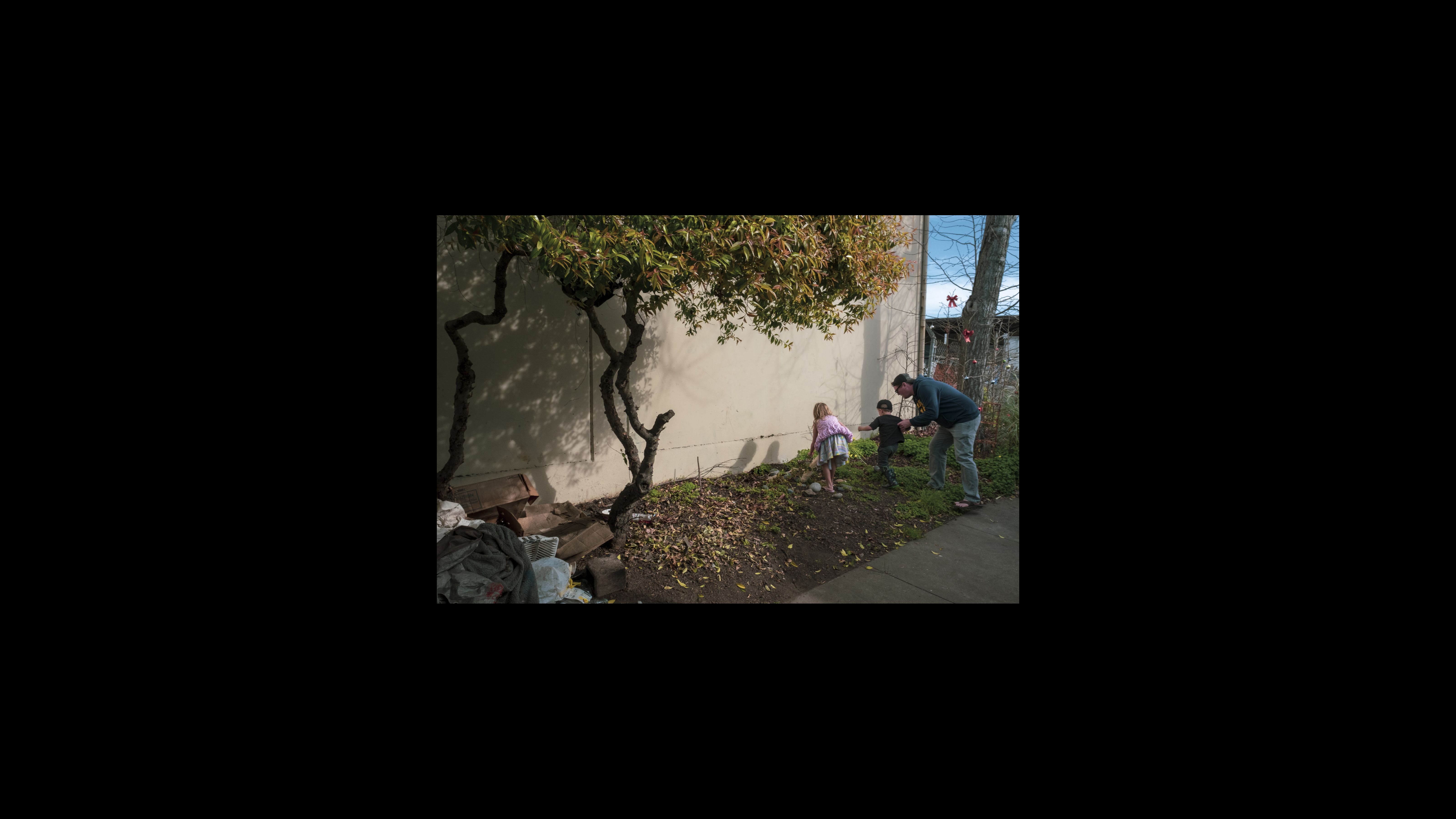 Children play in the green patch outside Merced Dominguez’s recreational vehicle. A father pulls his son away from her plants and garden decorations. He tells his children it is time to go and to not touch anything else. Children play in the green patch outside Merced Dominguez’s recreational vehicle. A father pulls his son away from her plants and garden decorations. He tells his children it is time to go and to not touch anything else.