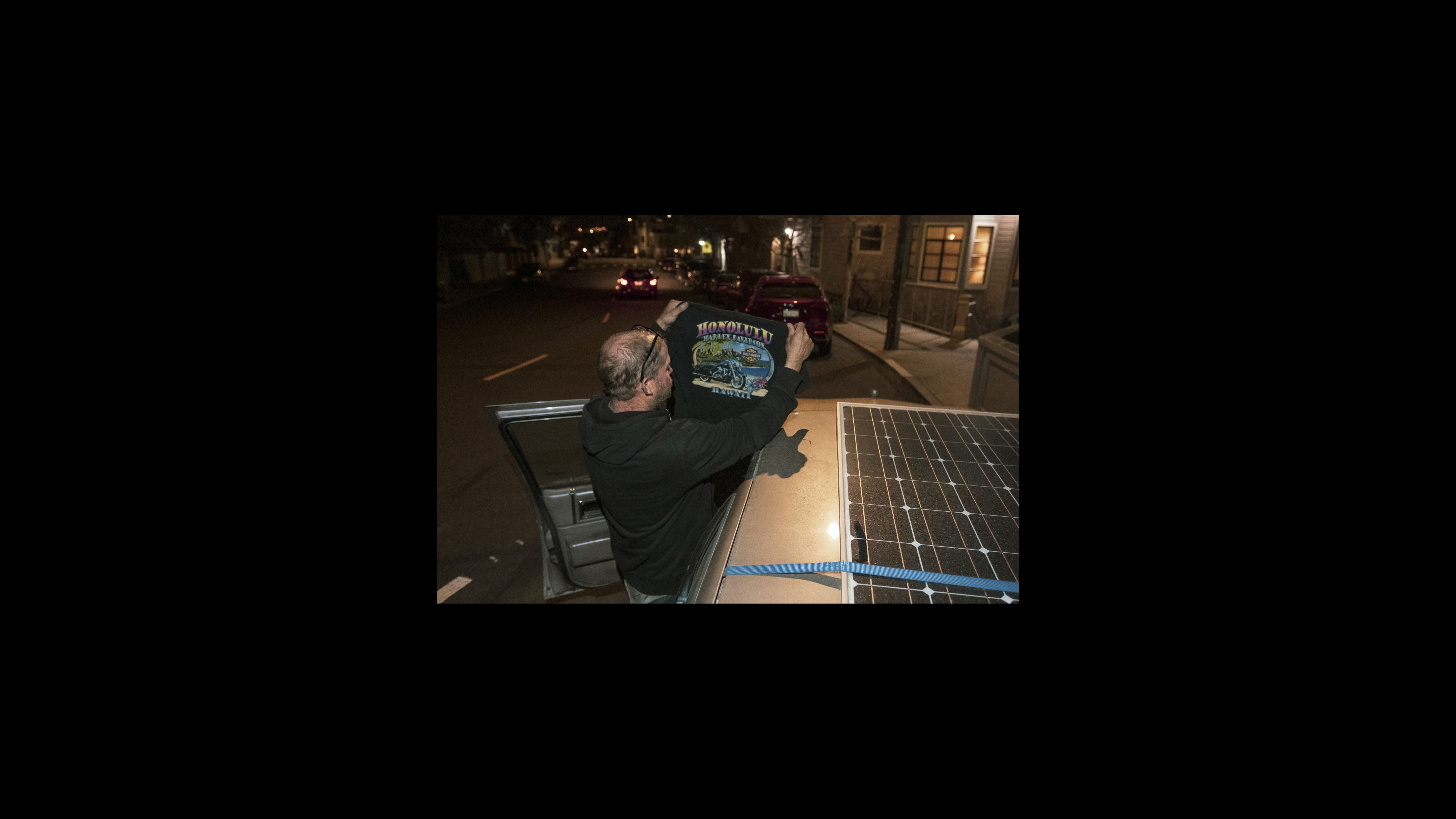 Nelson does not keep his vehicle near the tow yard because streets nearby are subject to regulations that prevent long-term parking. So he finds parking high on Potrero Hill. On this night, Nelson looks through his clean laundry for a shirt. He pulls out a souvenir T-shirt from an old vacation. After a divorce, his ex-wife kept the house. So he traveled to Hawaii to escape his problems and weigh options. Back in San Francisco, his first home on wheels was the RV. Nelson does not keep his vehicle near the tow yard because streets nearby are subject to regulations that prevent long-term parking. So he finds parking high on Potrero Hill. On this night, Nelson looks through his clean laundry for a shirt. He pulls out a souvenir T-shirt from an old vacation. After a divorce, his ex-wife kept the house. So he traveled to Hawaii to escape his problems and weigh options. Back in San Francisco, his first home on wheels was the RV.