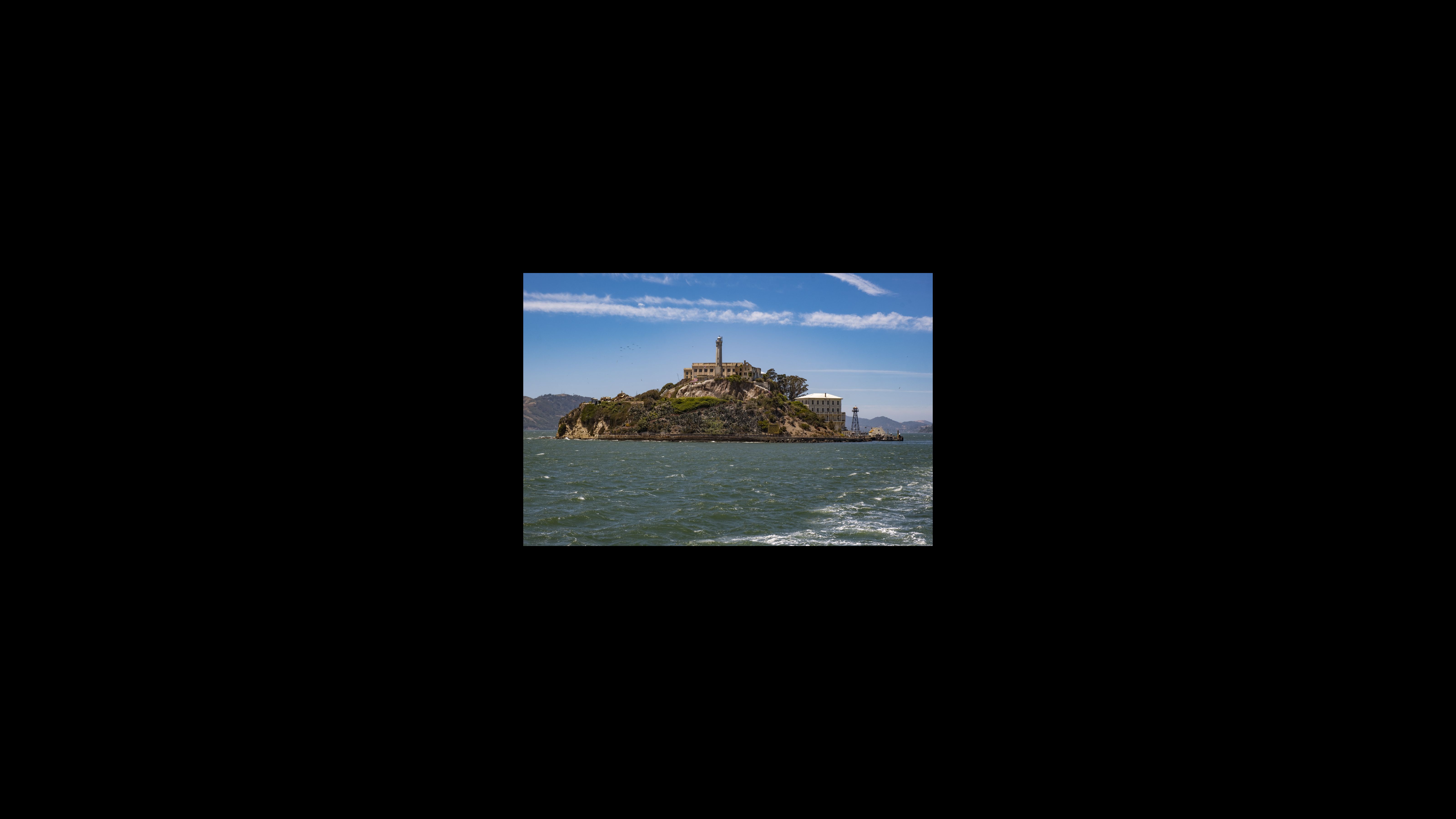 Alcatraz’s natural features include rock pools and colonies of seabirds such as western gulls, cormorants and egrets. The 12-acre island’s structures include the oldest operating lighthouse on the West Coast, a decommissioned military outpost and the abandoned federal prison. In 1850, President Millard Fillmore signed an executive order to turn Alcatraz into a military fortress. It served as a military prison from 1857 to 1933, during which it housed prisoners of war, including Native Americans from American-Indian Wars. View of Alcatraz, approaching by ferry