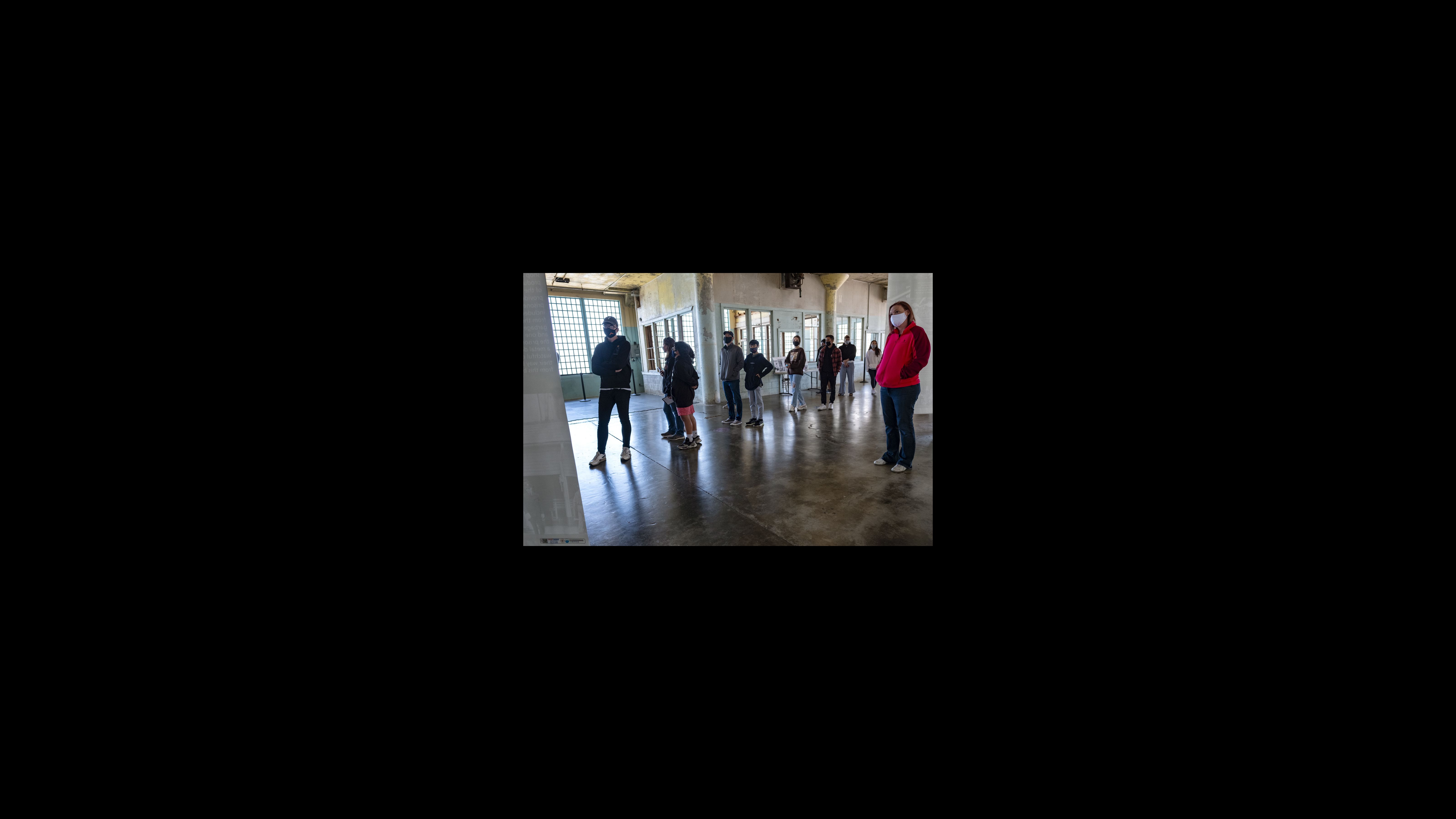 Visitors view the large canvas posters in the exhibition. “Red Power on Alcatraz” opened Nov. 20, 2019, marking the beginning of the 50th anniversary of the occupation, with plans to run for 19 months, the length of the occupation. Due to COVID-19, Alcatraz was closed most of last year, so part of the exhibition was made available online. Now, it has been extended until the end of 2021. Visitors view the large canvas posters in the exhibition.