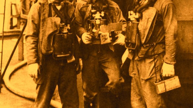 San Francisco Naval Shipyard workers who were sent aboard ships hit by an atomic bomb wore protective clothing and devices to check radiation levels. Source: Drydocker Newspaper, 1952, via National Archives and Records Administration. Photo editing by Stacey Carter.