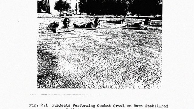 Mock atomic combat: Soldiers crawl through a field of radioactive dirt at Camp Stoneman in 1958. Source: Naval Radiological Defense Laboratory via National Archives and Records Administration. Grainy black-and-white image of three soldiers wearing helmets and crawling through a field.